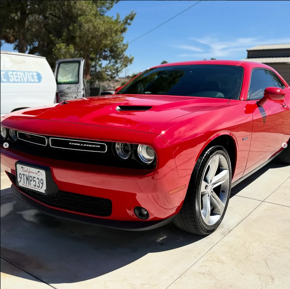 Red Dodge Challenger after collision body and paint repair.